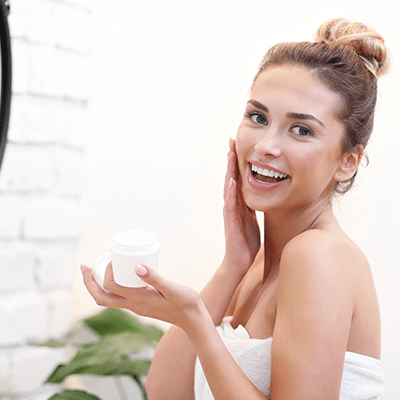 Woman puts on skin cream